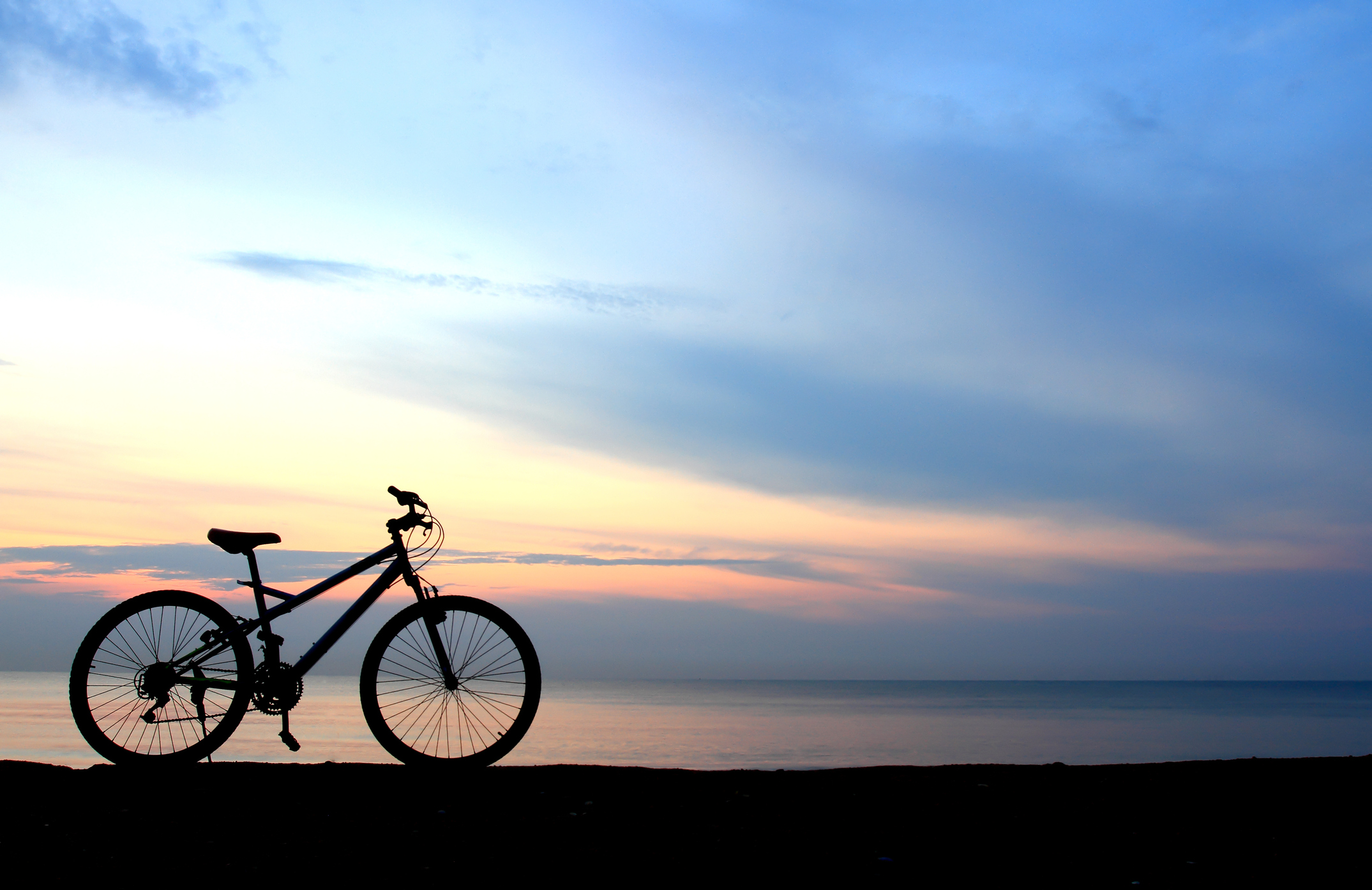 One of the best 30A bike trails with a bike against a sunset background