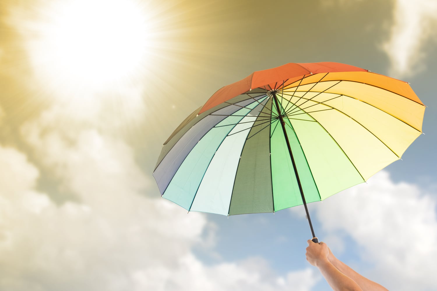 Rainbow colored umbrella; Things to Do at the Beach When it Rains