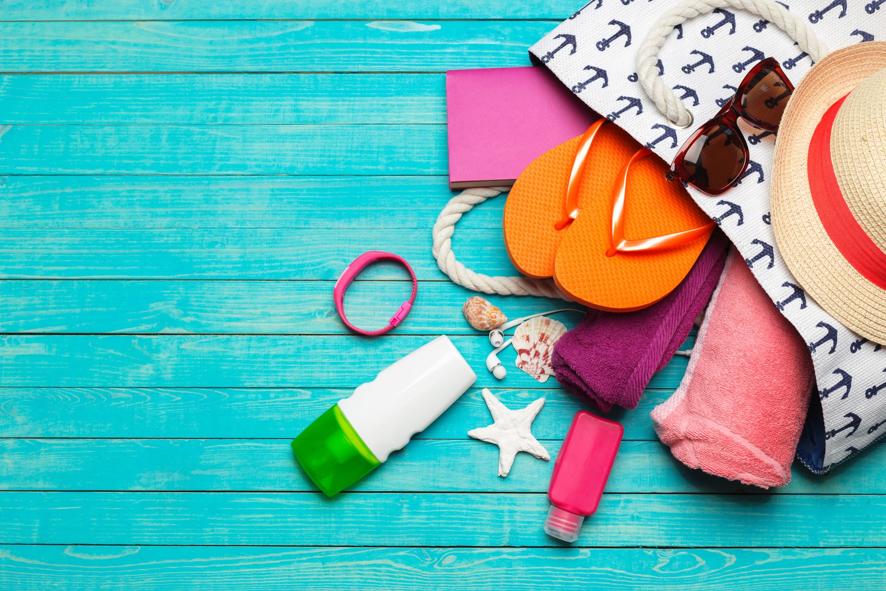 Beach Bag Accessories on a Blue Wooden Table