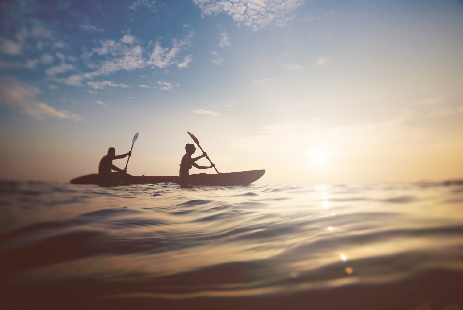 people on boat at sunset